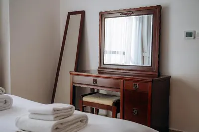 a mirror sitting on top of a dresser next to a bed at Top Holiday Location - Walk to Beach - Free Pool & Gym in Dubai