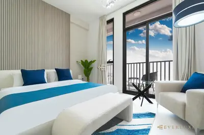 a bedroom with a bed and a balcony at Cozy Studio With Style Midtown Retreat - Impz in Dubai