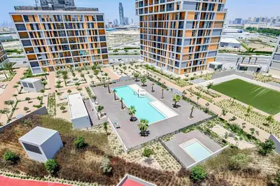 an aerial view of a park with a pool and buildings at Cozy Studio With Style Midtown Retreat - Impz in Dubai