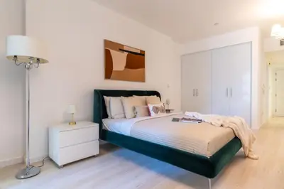 a bedroom with a bed and a lamp in it at The Smart Concierge - Murjan in Dubai