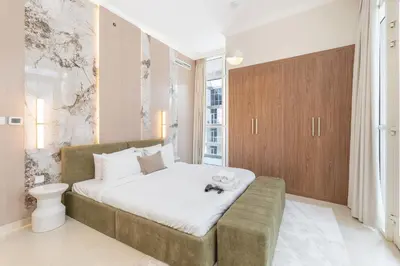 a bedroom with a large bed with white sheets at Amal أمل Cozy City Apt 3BD with balconies, 1 min walk to Dubai Mall- Dar Samita Holiday Homes in Dubai