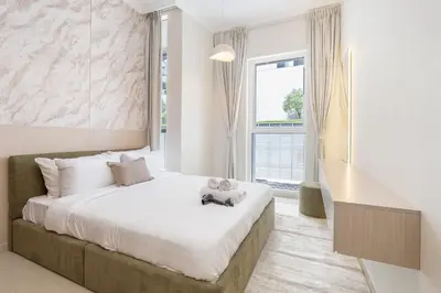 a bedroom with a large bed and a window at Amal أمل Cozy City Apt 3BD with balconies, 1 min walk to Dubai Mall- Dar Samita Holiday Homes in Dubai