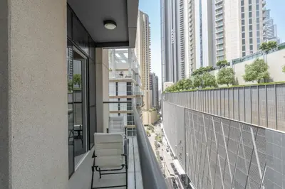 a balcony with chairs and a view of a city at Amal أمل Cozy City Apt 3BD with balconies, 1 min walk to Dubai Mall- Dar Samita Holiday Homes in Dubai