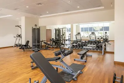 a gym with several treadmills and exercise bikes at Amal أمل Cozy City Apt 3BD with balconies, 1 min walk to Dubai Mall- Dar Samita Holiday Homes in Dubai