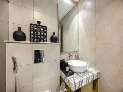 a bathroom with a sink and vases on a shelf at Livin' Holiday - Studio - Cozy Flat in Business Bay in Dubai