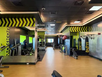 a gym with treadmills and cardio equipment on the walls at The Smart Concierge - Elite Residence in Dubai