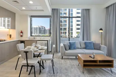 a living room with a couch and a table at Upscale 1 Bedroom Apartment - Azizi Riviera 27 - Allsopp & Allsopp in Dubai