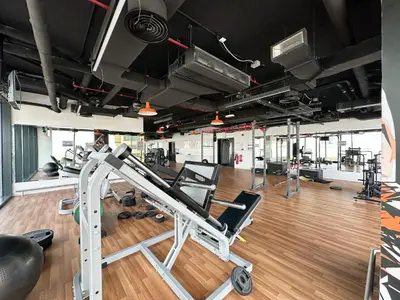 a gym with several treadmills and a treadmill at Golden Glow Getaway 1BR in JVC in Dubai