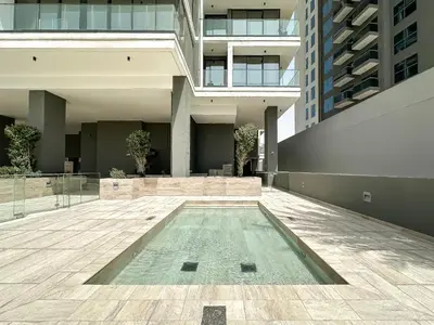 a swimming pool in the middle of a building at Golden Glow Getaway 1BR in JVC in Dubai