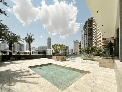 a swimming pool on the roof of a building at Golden Glow Getaway 1BR in JVC in Dubai