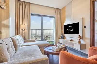 a living room with a couch and a tv at STAY BY LATINEM Luxury 1BR Holiday Home CB 1008 Near Burj Khalifa in Dubai