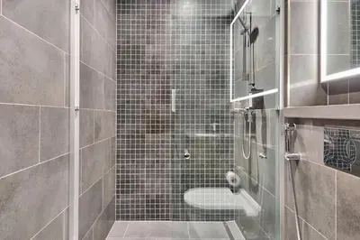 a bathroom with a glass shower with a toilet at STAY BY LATINEM Luxury 1BR Holiday Home CB 1008 Near Burj Khalifa in Dubai