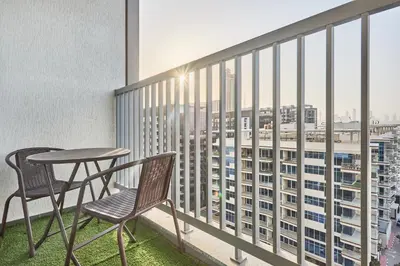 a balcony with a table and chairs and a view of a city at STAY BY LATINEM Luxury 1BR Holiday Home CB 1008 Near Burj Khalifa in Dubai