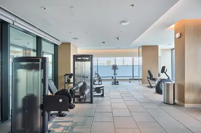 a gym with treadmills and exercise equipment in a building at STAY BY LATINEM Luxury 1BR Holiday Home CB 1008 Near Burj Khalifa in Dubai