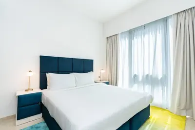 a bedroom with a large bed and a large window at CitiHome Stylish Design Prime Location in Dubai