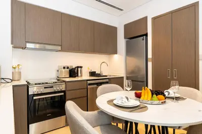 a kitchen with a table with a bowl of fruit on it at CitiHome Stylish Design Prime Location in Dubai