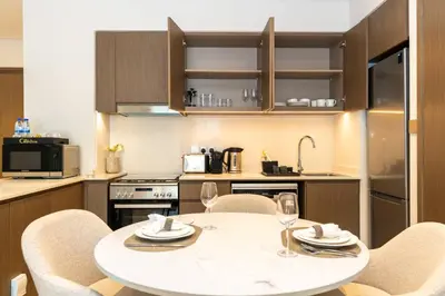 a kitchen with a table and chairs in a kitchen at CitiHome Stylish Design Prime Location in Dubai