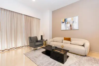 a living room with a couch and a chair at CitiHome Stylish Design Prime Location in Dubai