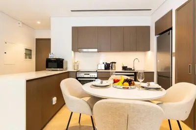 a kitchen with a table with a bowl of fruit on it at CitiHome Stylish Design Prime Location in Dubai