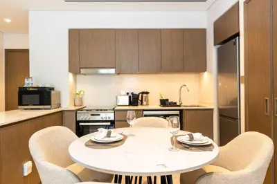 a kitchen with a table and chairs in a kitchen at CitiHome Stylish Design Prime Location in Dubai