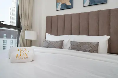 a hotel room with a large bed with a pillow on it at Elegant 1 Bed Creek Beach Stay with Beach Access in Dubai