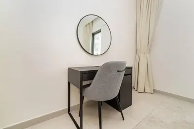 a desk with a chair and a mirror at Elegant 1 Bed Creek Beach Stay with Beach Access in Dubai