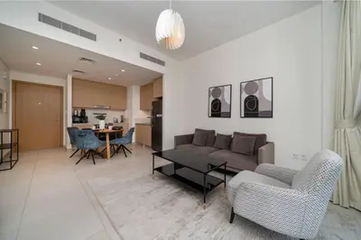 a living room with a couch and chairs and a table at Elegant 1 Bed Creek Beach Stay with Beach Access in Dubai
