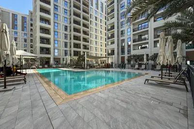 a swimming pool in the middle of a building at Elegant 1 Bed Creek Beach Stay with Beach Access in Dubai