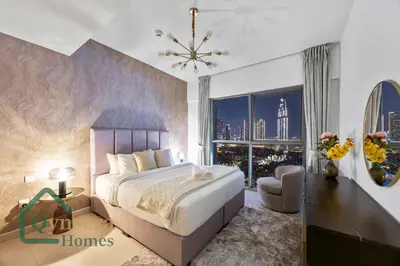 a bedroom with a large bed and a large window at Luxury Stay Skyline Burj View in Dubai