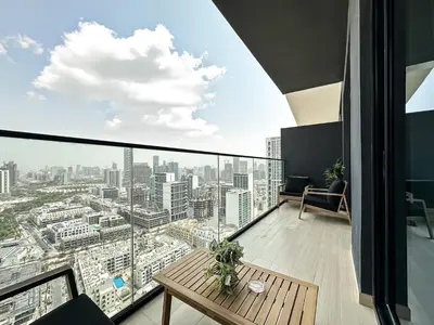 an office with a view of a city at Modern 1BR Haven in Prime JVC Spot in Dubai