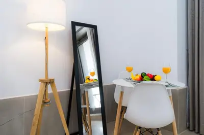 a table with a plate of fruit and a mirror at Cozy - Accessible to Tram - Convenient in Dubai