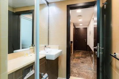 a bathroom with a sink and a mirror at Cozy - Accessible to Tram - Convenient in Dubai
