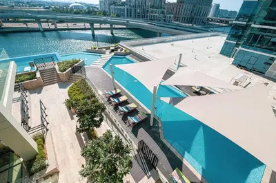 an overhead view of a swimming pool on a building at FIRST CLASS 2BR Luxury Canal & Pool Views in Dubai