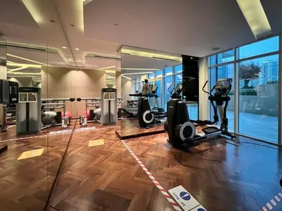 a gym with treadmills and ellipticals in a building at GuestReady - City Nest | Balcony | Majestine Tower in Dubai