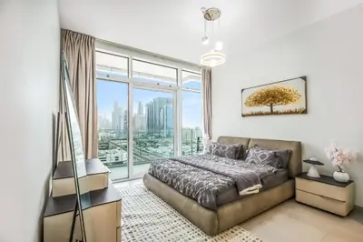 a bedroom with a bed and a large window at Elegant 1BHK Metro Access & Trade Centre in Dubai