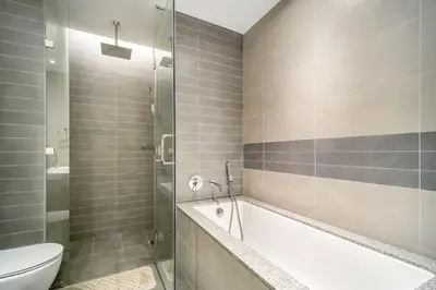 a bathroom with a bath tub and a toilet at Elegant 1BHK Metro Access & Trade Centre in Dubai