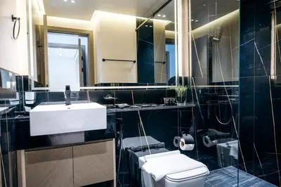 a bathroom with a sink and a toilet and a mirror at Cozy 1BR Apartment with Pool & Parking JVC Dubai in Dubai