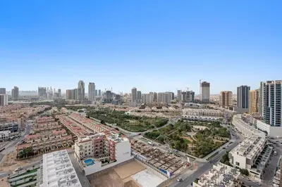 an aerial view of a city with tall buildings at Cozy 1BR Apartment with Pool & Parking JVC Dubai in Dubai