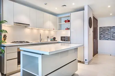 a kitchen with white cabinets and a sink at STAY BY LATINEM Luxury 2BR Holiday Home CVG 807 Near Downtown in Dubai