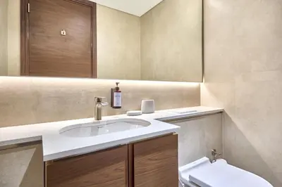 a bathroom with a sink and a toilet and a mirror at STAY BY LATINEM Luxury 2BR Holiday Home CVG 807 Near Downtown in Dubai