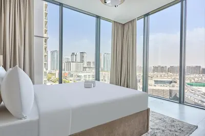a bedroom with a large white bed and large windows at STAY BY LATINEM Luxury 2BR Holiday Home CVG 807 Near Downtown in Dubai