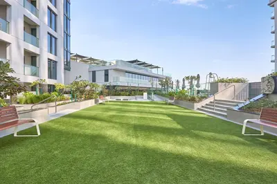 a lawn in the middle of a building with benches at STAY BY LATINEM Luxury 2BR Holiday Home CVG 807 Near Downtown in Dubai