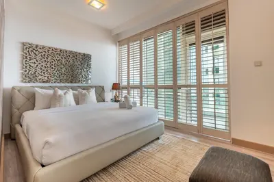 a bedroom with a bed and a large window at Walking Distance to Bluewaters Island, with The Walk JBR right at your Door and Private Beach Access, Al Bateen Residences, JBR by Deluxe Holiday Homes in Dubai