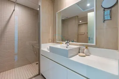 a bathroom with a white sink and a shower at Walking Distance to Bluewaters Island, with The Walk JBR right at your Door and Private Beach Access, Al Bateen Residences, JBR by Deluxe Holiday Homes in Dubai