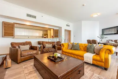 a living room with a yellow couch and leather chairs at Walking Distance to Bluewaters Island, with The Walk JBR right at your Door and Private Beach Access, Al Bateen Residences, JBR by Deluxe Holiday Homes in Dubai