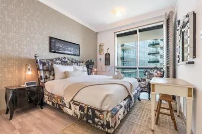 a bedroom with a bed and a desk and a window at Walking Distance to Bluewaters Island, with The Walk JBR right at your Door and Private Beach Access, Al Bateen Residences, JBR by Deluxe Holiday Homes in Dubai