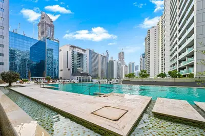 a swimming pool in a city with tall buildings at Live in the Center - Walk to Dubai Icons in Dubai