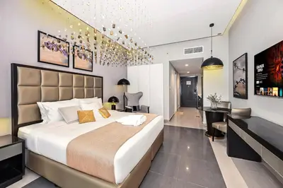a bedroom with a large bed and a desk at Live in the Center - Walk to Dubai Icons in Dubai