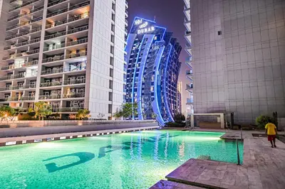 a swimming pool in a city with tall buildings at Live in the Center - Walk to Dubai Icons in Dubai