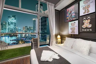 a bedroom with a large window with a view of a city at Chic Marina View - Timeless Studio Escape in Dubai